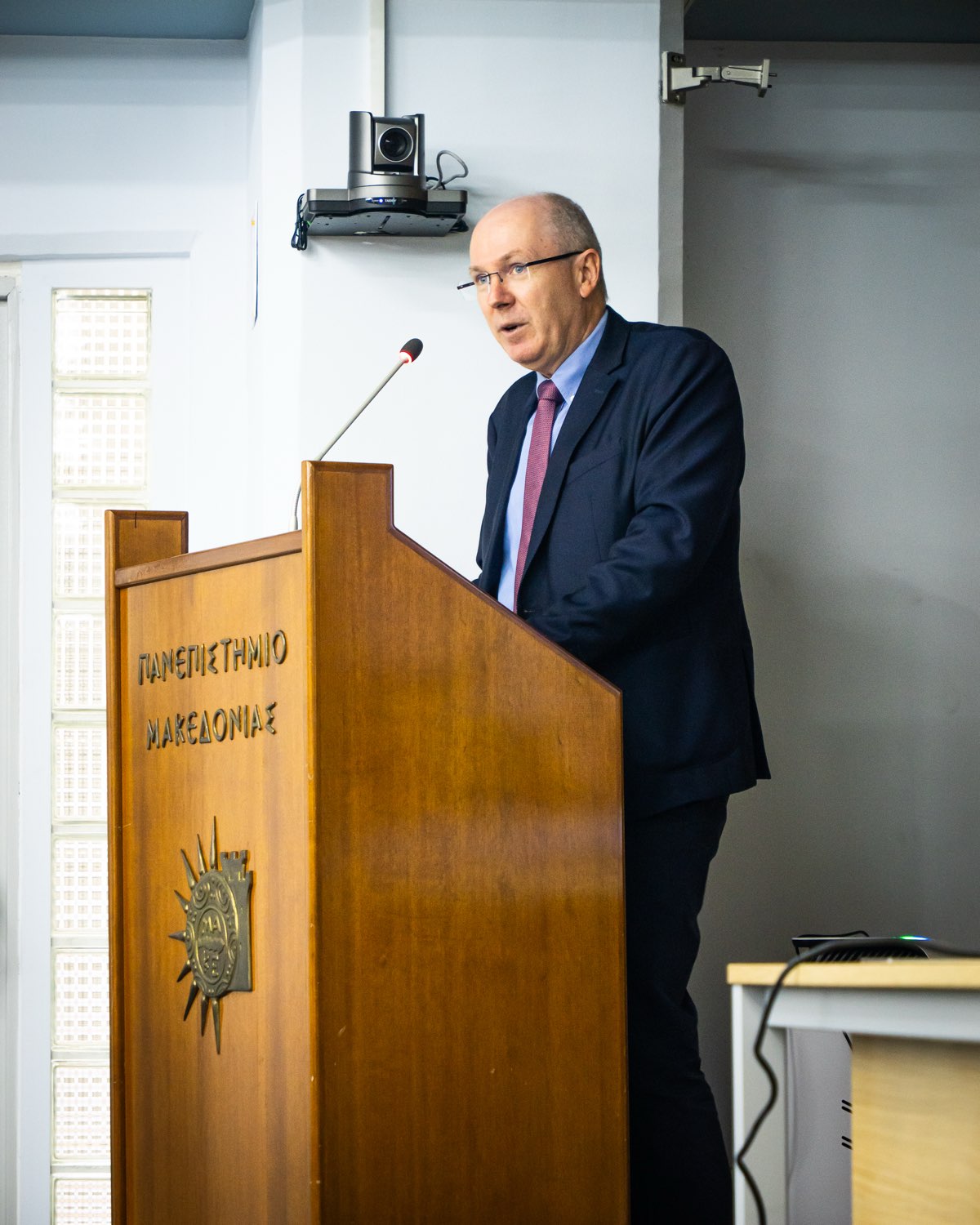 A speaker addressing the conference from the lectern.