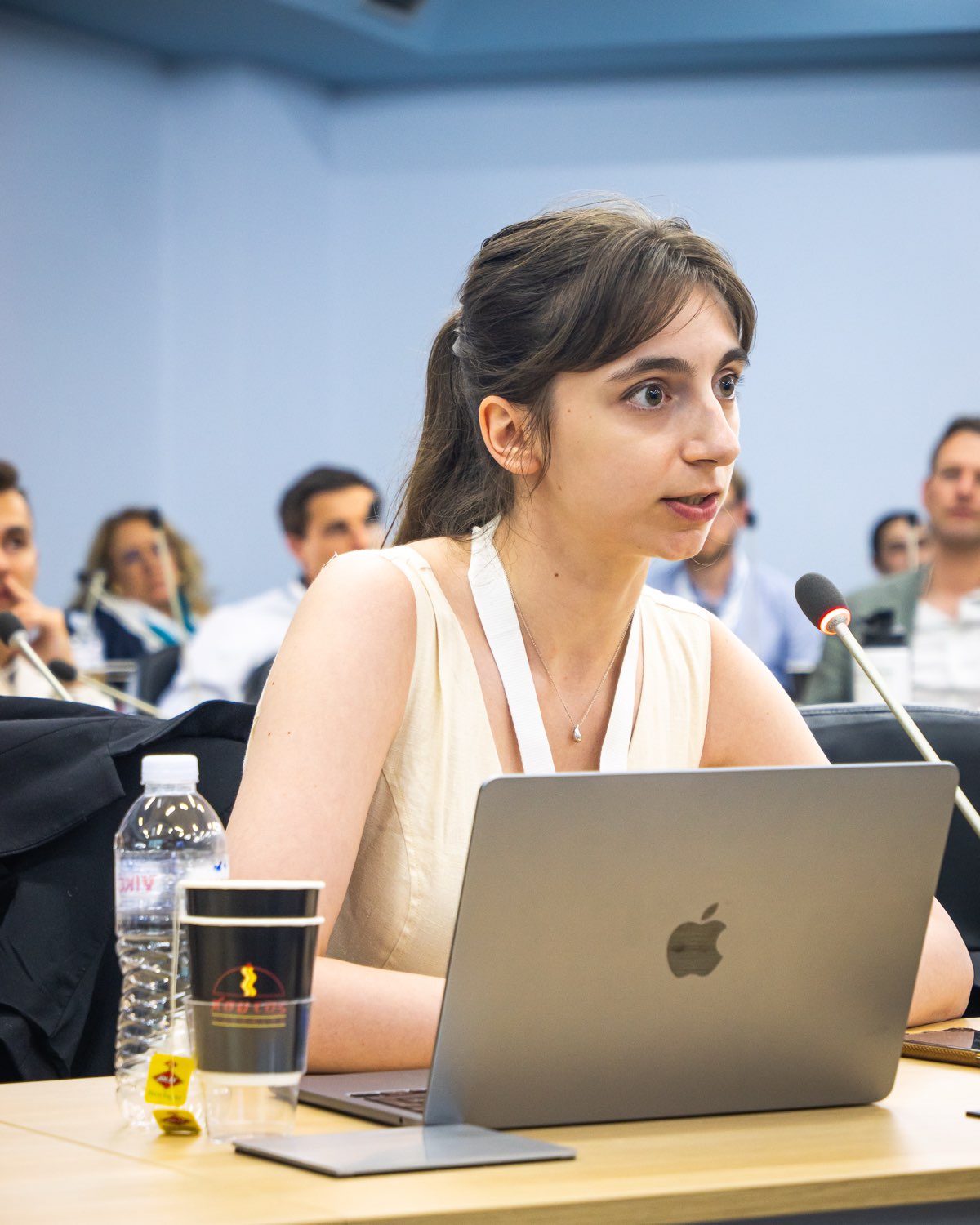 A participant presenting at the microphone during a panel.