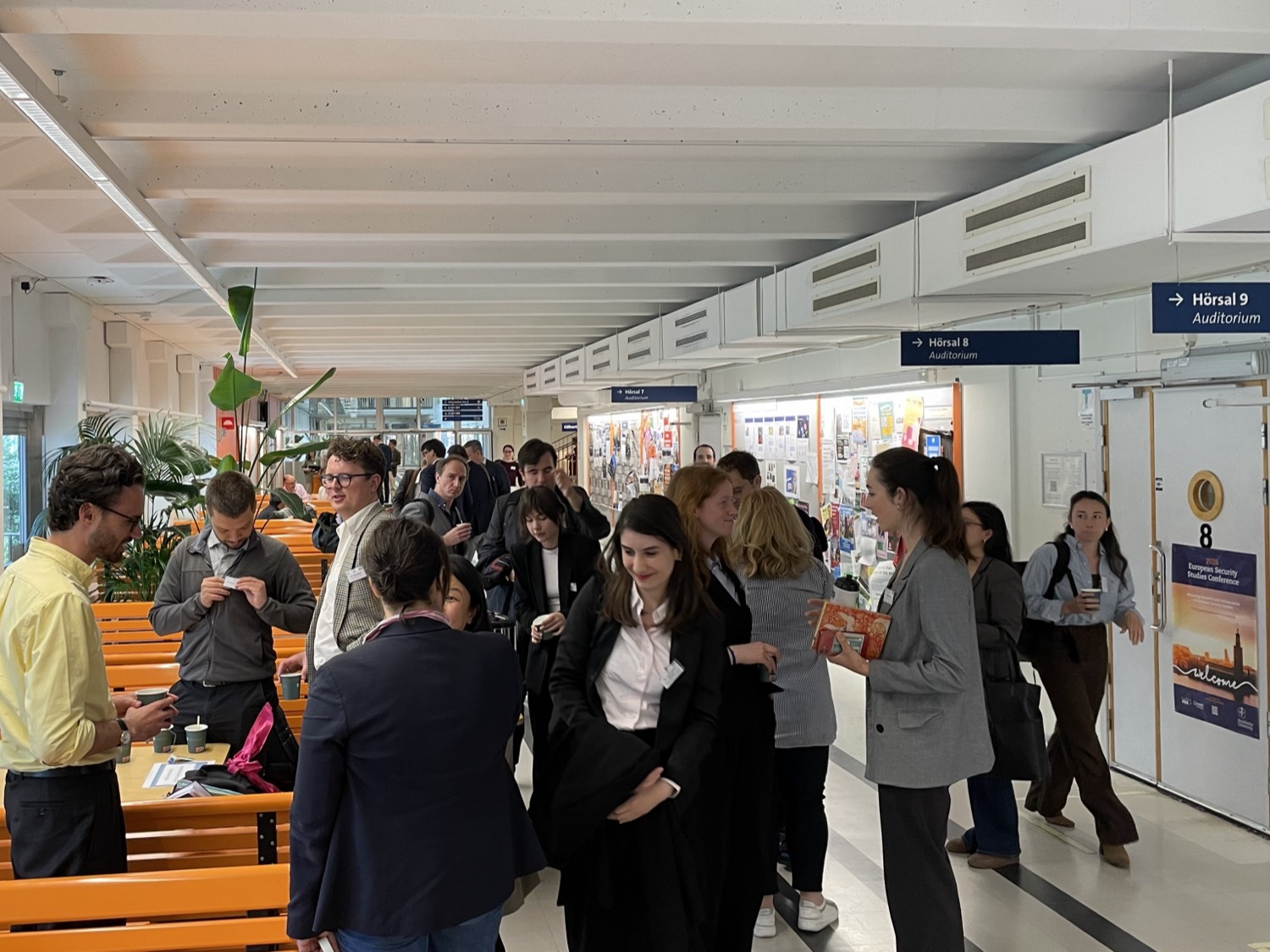 Delegates between sessions in the foyer at Stockholm University.
