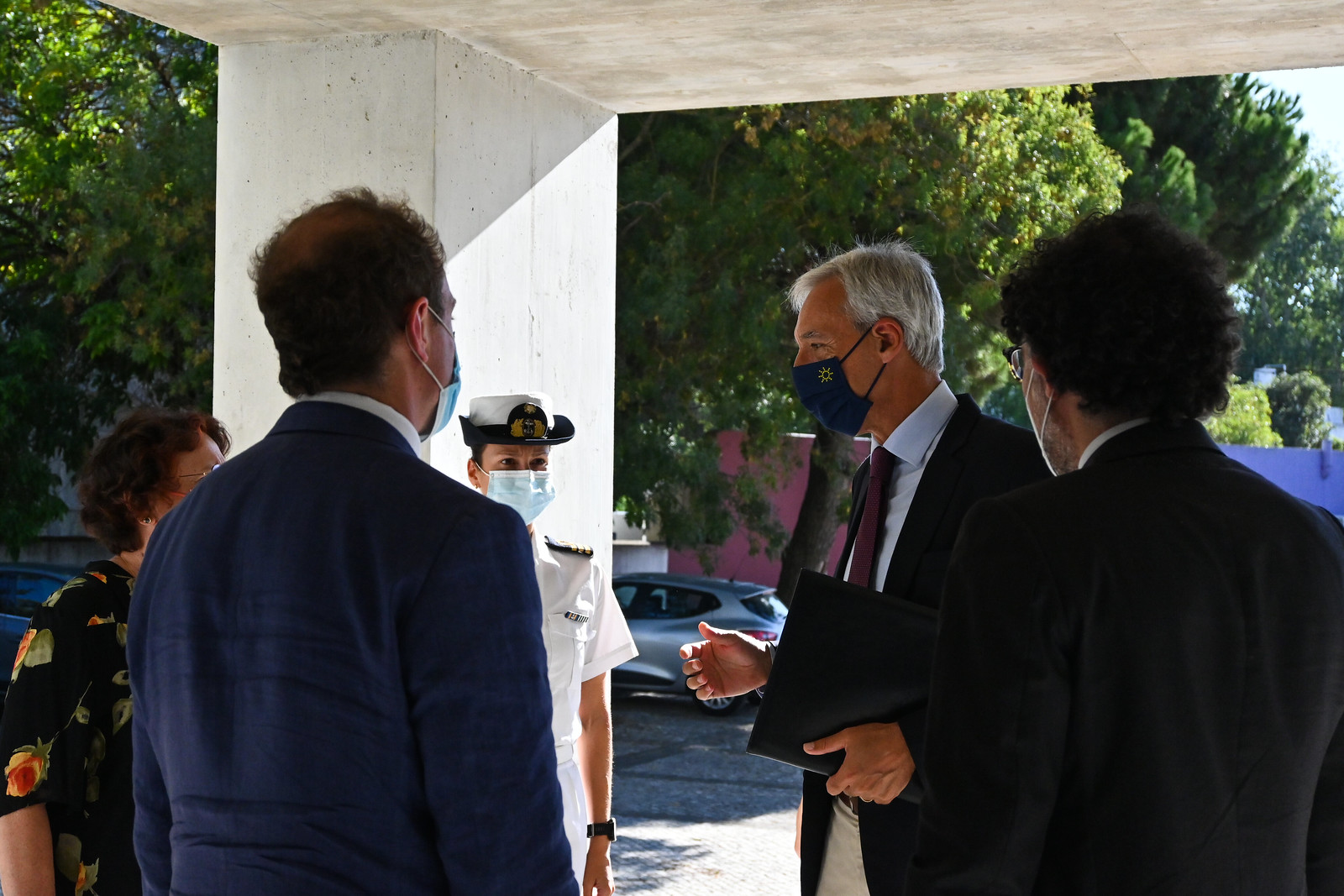 Delegates, including a naval officer, in conversation in the venue foyer at the 2021 EISS Conference, Lisbon.