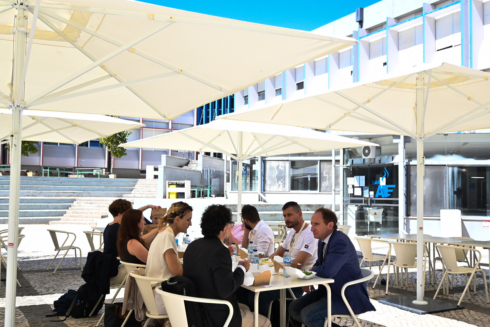 Delegates seated under parasols on the venue terrace during a break at the 2021 EISS Conference, Lisbon.